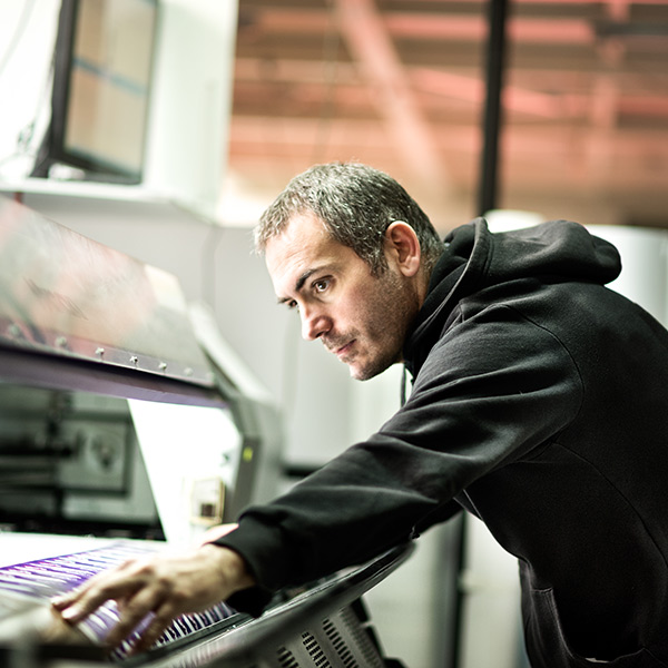a man with banner printing machine